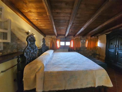 a bedroom with a large bed in a room at Il Palazzo delle Rondini in Magliano deʼ Marsi