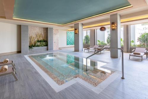 a pool in the middle of a living room with furniture at Hotel Riu Palace Maspalomas - Adults Only in Maspalomas