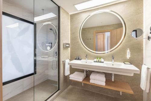 a bathroom with a sink and a mirror at Hotel Riu Palace Maspalomas - Adults Only in Maspalomas