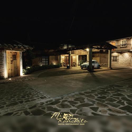 a car parked in front of a building at night at Mi Ranchito Chignahuapan Hotel in Chignahuapan