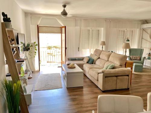 a living room with a couch and a table at Céntrico ,Moderno y confortable Apartament in Almería