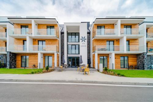 an apartment building with a table in front of it at Zuberka Vila Zuberec in Zuberec