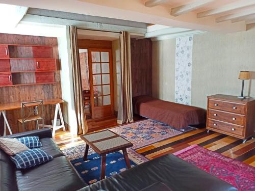 un salon avec un canapé et un lit dans l'établissement DUPLEX 