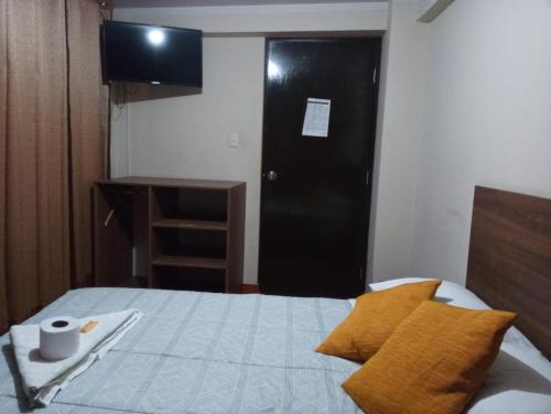 Ένα ή περισσότερα κρεβάτια σε δωμάτιο στο Cálido Hostal