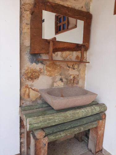 a bathroom with a stone sink on a wall at Finca Hotel El Paraíso in Barbosa