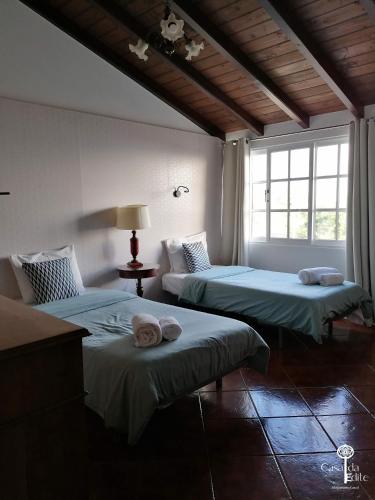 a room with two beds and a window at Casa da Edite in Ponta do Sol