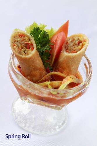 a glass bowl filled with some food in it at The Lokha Legian Resort & Spa in Legian