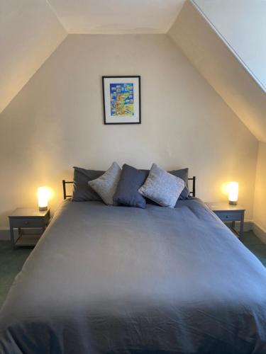 a bedroom with a large bed with two lamps at The Annex Keith Self Catering WiFi Private Parking bkng in Keith