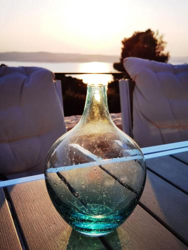 a glass vase sitting on top of a table at Damari Luxury Retreat Villas Skiathos in Skiathos Town