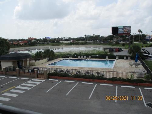 a pool in the middle of a parking lot at Quality Inn & Suites Kissimmee by The Lake in Orlando