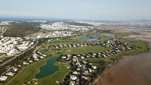 an aerial view of a golf course next to the water at The Residence Tunis in Gammarth