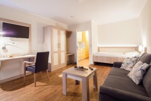 a living room with a couch and a table at GDA Hotel Göttingen in Göttingen