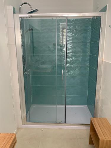 a shower with glass doors in a bathroom at Miriasol Bed and Breakfast in Capo Vaticano