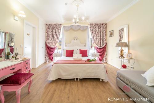 a large bedroom with a large bed with red pillows at 7 Styles Apartments by Raspberry Cascade in Faro