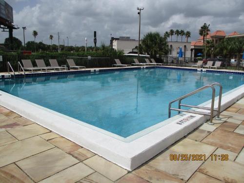 a large pool with blue water in a resort at Quality Inn & Suites Kissimmee by The Lake in Orlando