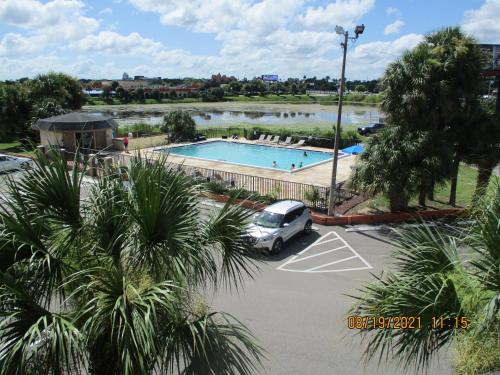 a car parked in a parking lot next to a swimming pool at Quality Inn & Suites Kissimmee by The Lake in Orlando