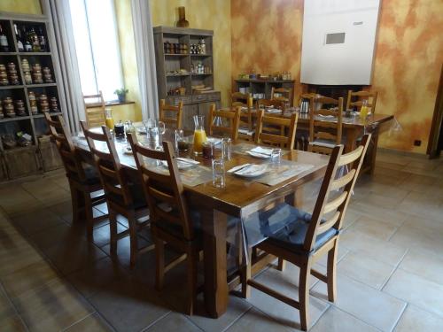 a dining room with a wooden table and chairs at La Lauriére in Treize-Vents