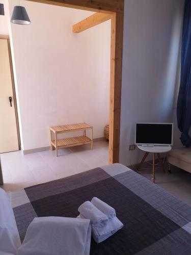a bedroom with a bed with two towels on it at Borgo Marino Plemmirio in Siracusa