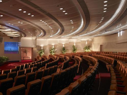 an auditorium with rows of chairs and a stage at Crowne Plaza Shenzhen Futian, Near to Shenzhen Convention&Exhibition Centre, Shenzhen Stock Exchange and Shenzhen Civic Center, Outdoor Heated Pool in Shenzhen