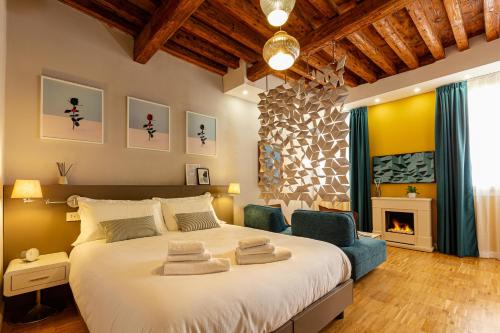 a bedroom with a large bed and a fireplace at Fraivolti apartment in Venice