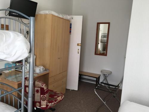 a bedroom with a bunk bed and a wooden cabinet at The Address in Blackpool