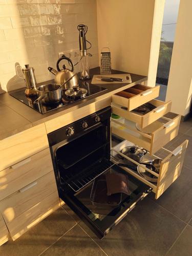a kitchen with an open oven with pots and pans at CANARIO in Las Indias