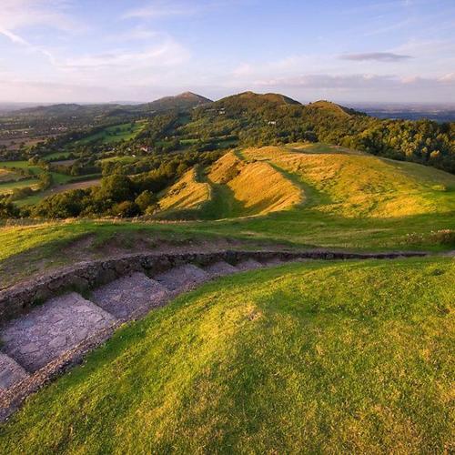 an aerial view of a green field with hills at By the Way in Great Malvern