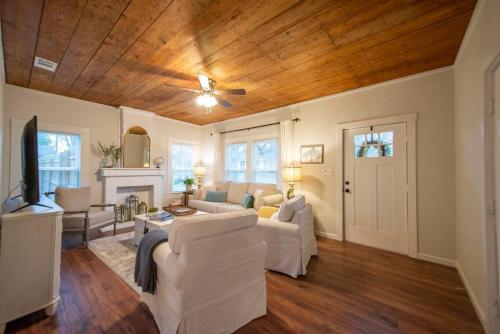 a living room with white furniture and a wooden ceiling at NEW-Ethel Rose Cottage-5 min to Magnolia Silos in Waco