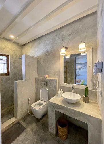 a bathroom with a sink and a toilet at Villa Huruma in Paje