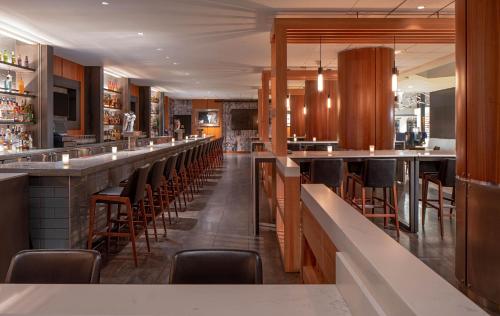 a bar with a row of bar stools at Hyatt Regency Indianapolis at State Capitol in Indianapolis