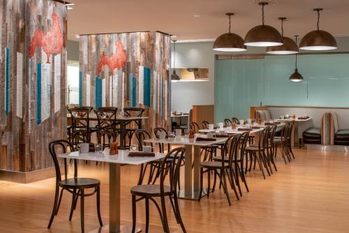 a row of tables and chairs in a restaurant at Hyatt Regency Indianapolis at State Capitol in Indianapolis