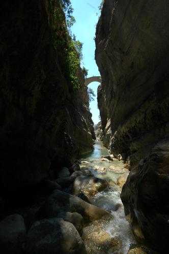 a bridge over a river in a rocky canyon at Il Belvedere in Civita