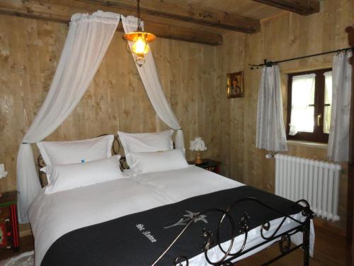 a bedroom with a large bed with a canopy at St. Anton in Grainau