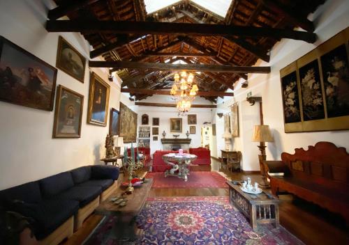 a living room with a couch and a table at Hotel Boutique Casa San Marcos in Quito