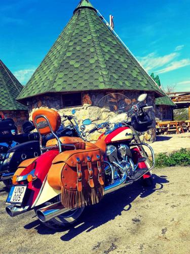 a red motorcycle parked in front of a building at KOZAK Apartments & Restaurant in Mojkovac