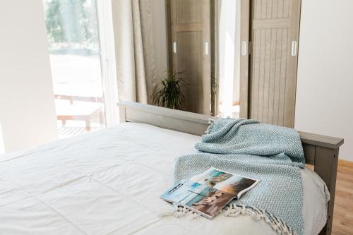 a bedroom with a bed with a magazine on it at Peaceful Palace in Silla