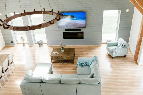 a living room with a couch and a tv at Peaceful Palace in Silla