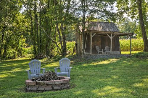 two chairs in a yard with a gazebo at Secluded Lothian Farmhouse on 45 Acres with Fire Pit in Lothian