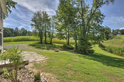 an empty yard with trees and a path at Secluded Lothian Farmhouse on 45 Acres with Fire Pit in Lothian