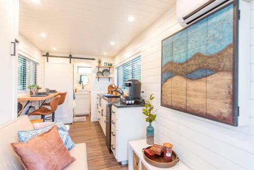a kitchen and living room in a tiny house at NEW The Brazos-Tiny Home 12 Min to downtown in Bellmead