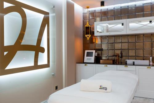 a kitchen with a white table and a microwave at Hotel & SPA Hetman in Siedlce