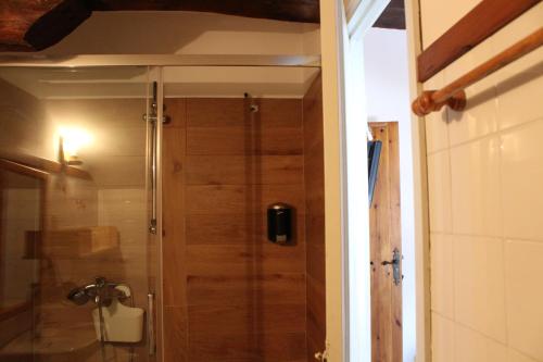 La salle de bains est pourvue d'une douche avec une porte en verre. dans l'établissement vaquero casa rural alquiler completo, à Abiada