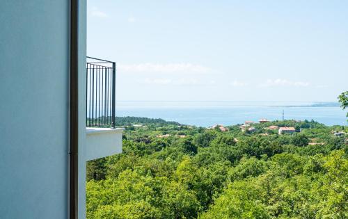 a room with a balcony with a view of trees at Encanto Agriturismo & Private SPA in Visogliano
