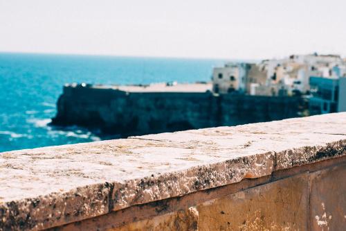 a stone wall with a view of the ocean at B&B Relais Del Senatore in Polignano a Mare