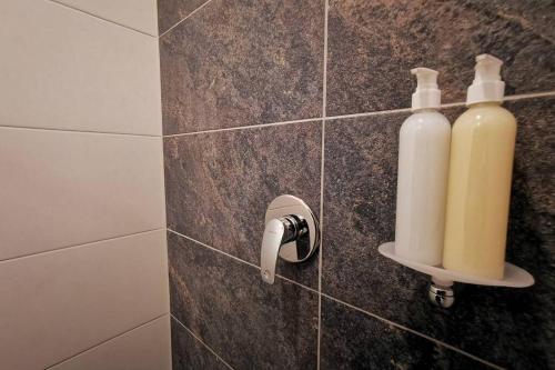 two bottles of soap are on a wall in a bathroom at Apartamento exclusivo en Manizales-Gran ubicación! in Manizales