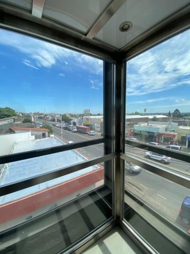 a view of a city from a window at Hotel Coé Verá in Paraná