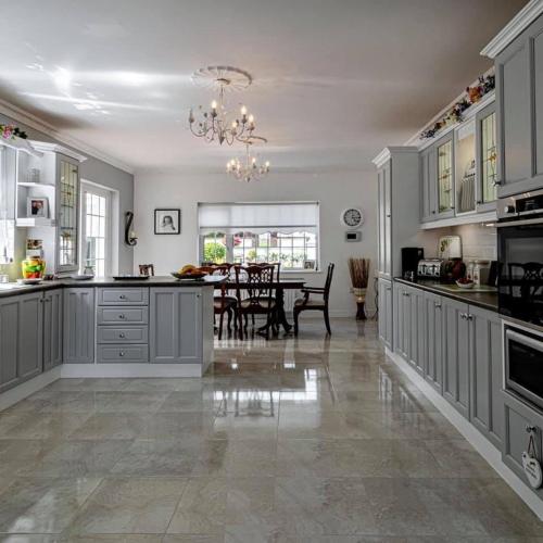 a large kitchen with a dining room and a table at Woodleigh Lodge in Gorey