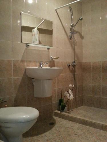 a bathroom with a toilet and a sink at Sea View Family Hotel in Kranevo