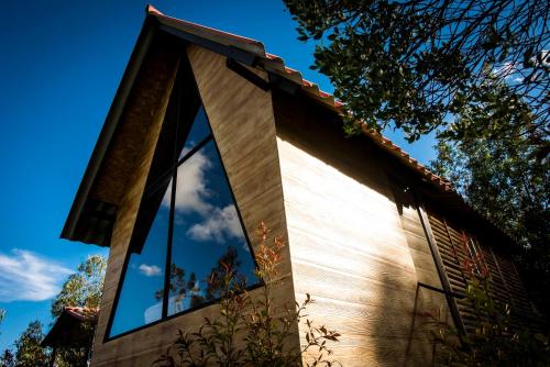 a house with a window on the side of it at Cabanas Villa Helena in Guatavita
