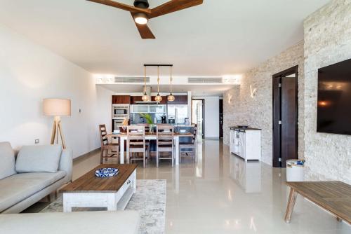 a living room with a couch and a table at Mareazul Beach Front Condos At playa del Carmen in Playa del Carmen